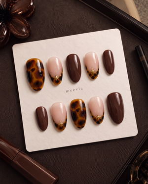 Amber tortoiseshell, chocolate brown, and nude pink star press-on nails