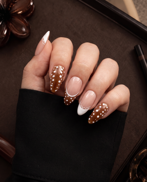 Brown and nude pink press-on nails with white polka dots, French tips, and scalloped accents