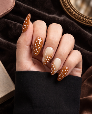 Brown and nude ombre press-on nails with glossy white spotted details