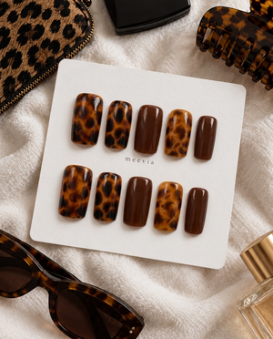 Brown glossy tortoiseshell press-on nails with amber and deep brown patterns