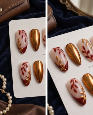 Burgundy and gold leaf floral press-on nails with nude bases and a burgundy French tip