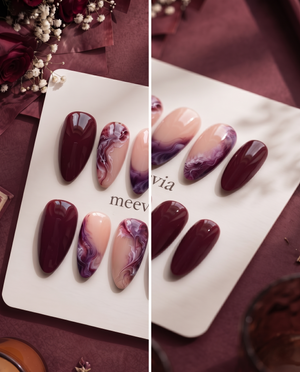Burgundy and pink glossy marble press-on nails displayed on a white card