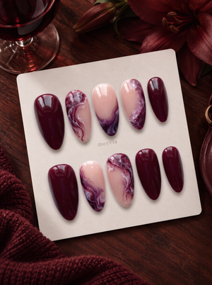 Burgundy and pink glossy marble press-on nails displayed on a white card
