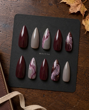 Burgundy and taupe glossy marble press-on nails with mauve swirls and gold flecks