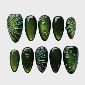 Set of emerald green cat eye press-on nails featuring 3D water drop details and fan-shaped textures.
