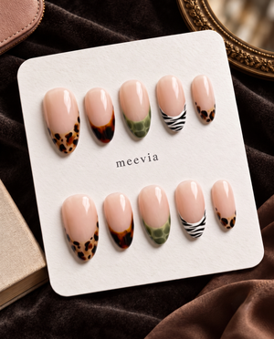 Glossy nude press-on nails with mixed tortoiseshell, olive, and zebra print French tips
