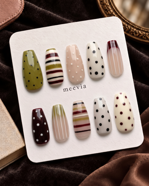 Mixed-pattern neutral press-on nails with olive, cream, nude, burgundy, black stripes and polka dots