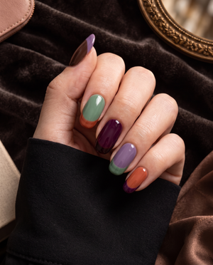 Multicolor glossy French tip press-on nails in brown, lavender, sage green, plum, and orange