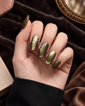 Olive cat-eye and black tiger-print press-on nails displayed on a white card