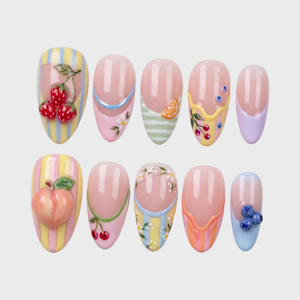 Pastel French tip press-on nails featuring 3d strawberries, blueberries, orange slices, and small daisy designs.