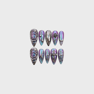 Set of press-on nails featuring a purple and teal cat-eye base with 3D chrome rose, cross, and liquid metal designs.