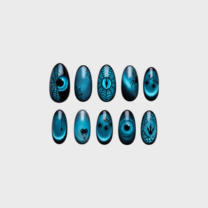 Teal cat-eye press-on nails with black spiderwebs, spiders, snake motif, claw marks, and reptile eye designs.