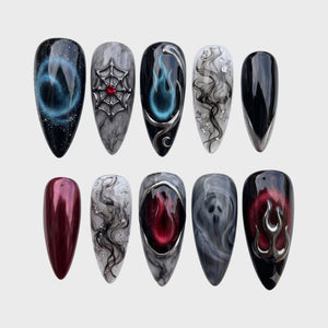 Gothic style press-on nails featuring black and red designs with 3D silver flames, a spiderweb, smoke effects, and a ghost face.