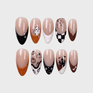 A set of ten almond-shaped press-on nails featuring a Halloween theme with ghosts, pumpkins, haunted houses, spiderwebs, and glittery orange and black French tips.