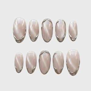 Set of press-on nails with a pearlescent cat-eye finish and silver liquid chrome metallic borders.
