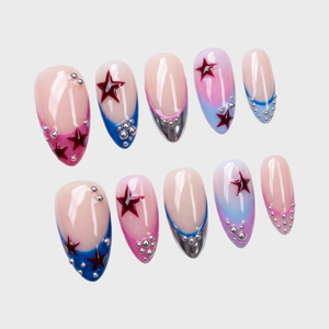 A set of press-on nails featuring a French tip design with red star accents and silver beads on a nude base.