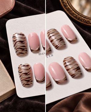 Taupe zebra stripe French tip press-on nails with pink center panels and shimmer accents