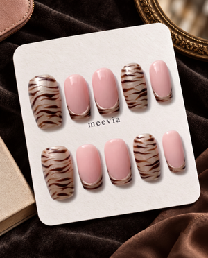 Taupe zebra stripe French tip press-on nails with pink center panels and shimmer accents