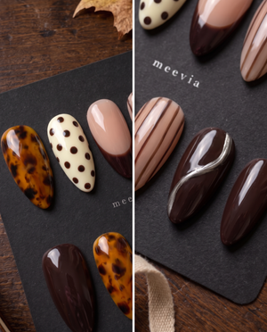 Brown tortoiseshell and striped press-on nails with glossy nude, ivory, and chocolate designs