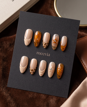 Nude and amber tortoiseshell swirl French tip press-on nails with spotted and rhinestone accents