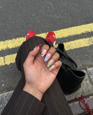 Toy Story inspired press-on nails with character themed French tips and star charms.