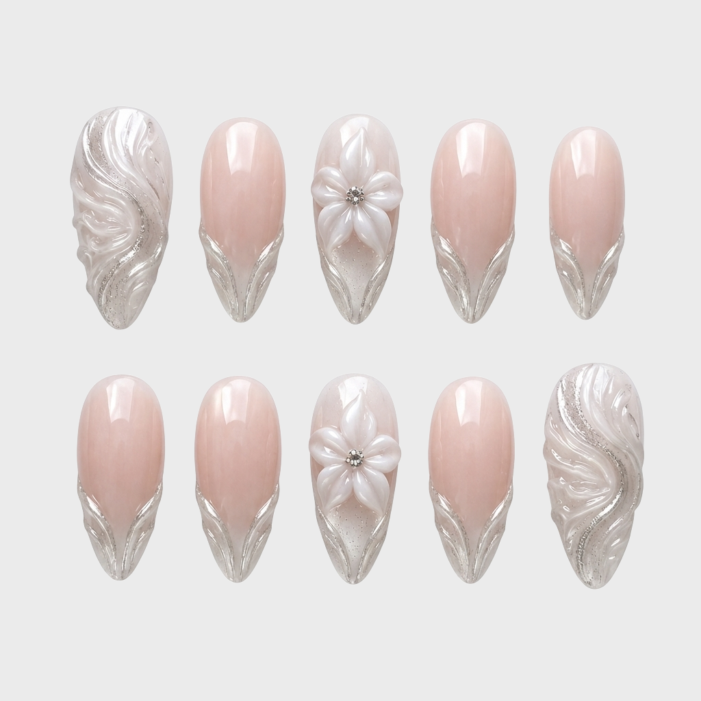 A set of nude press-on nails featuring 3D white flowers and metallic silver swirl designs.