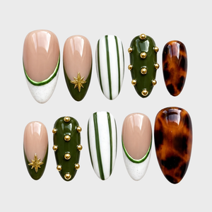 A set of press-on nails featuring olive green, tortoiseshell, and striped designs with gold star and stud accents.