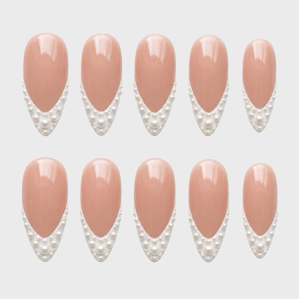 A set of nude press-on nails with white pearl French tips.