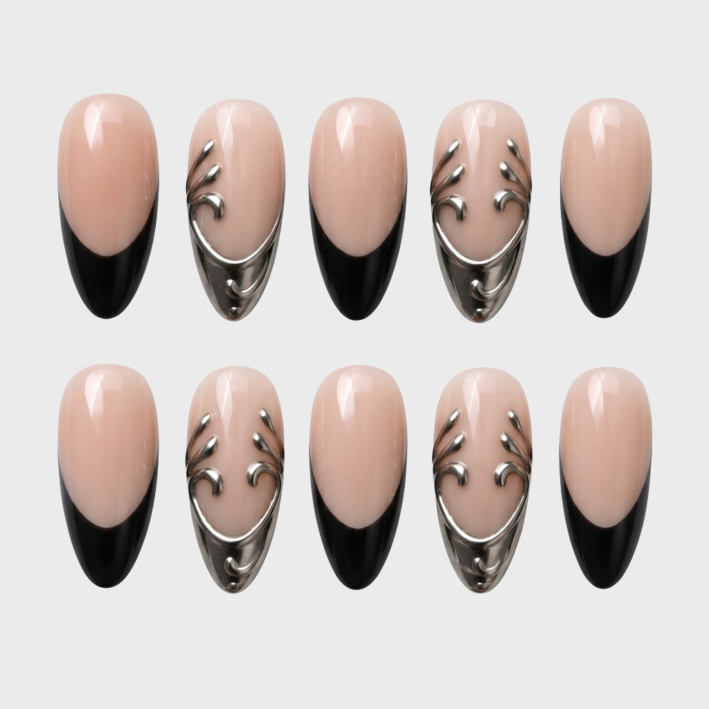 Nude and black French tip press-on nails with silver metallic scroll embellishments.