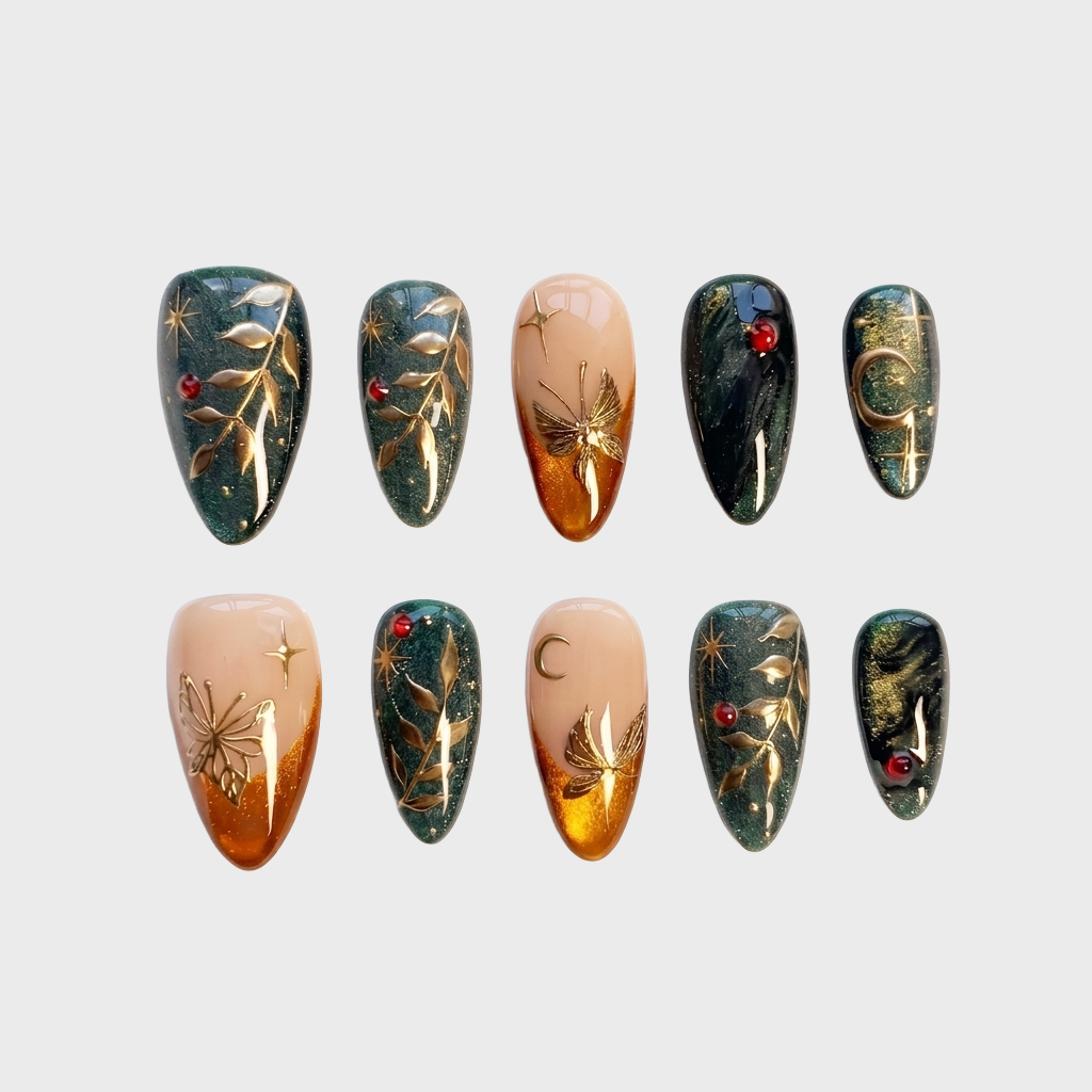 Forest green glitter press-on nails with gold leaf, celestial stars, crescent moons, and red gemstone accents.