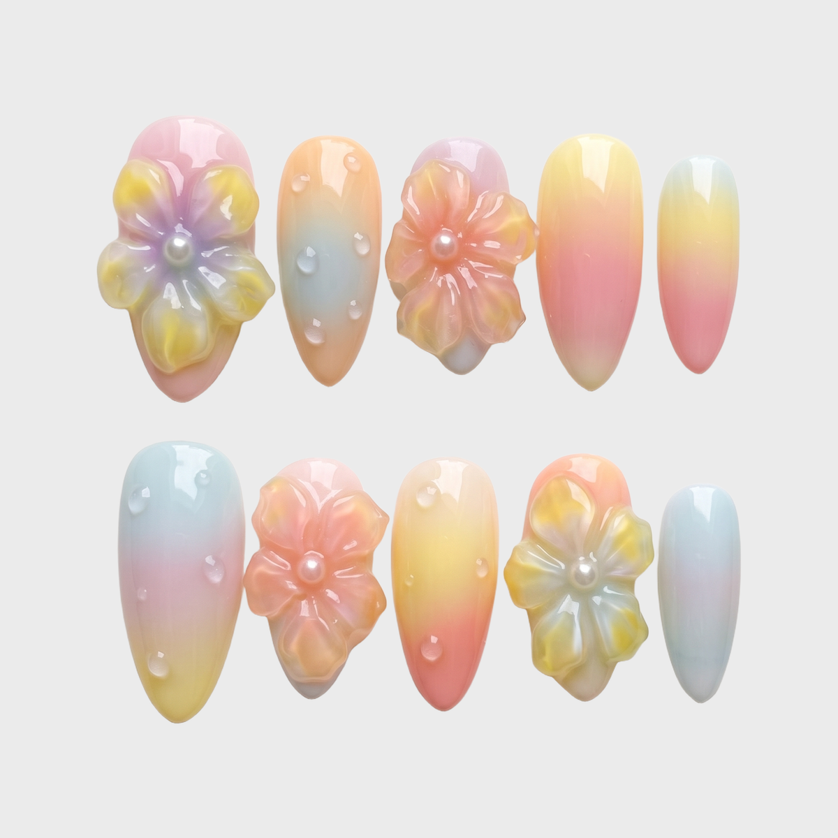 Pastel ombr������������ press-on nails with 3D jelly flowers, pearl centers, and clear water droplet accents.