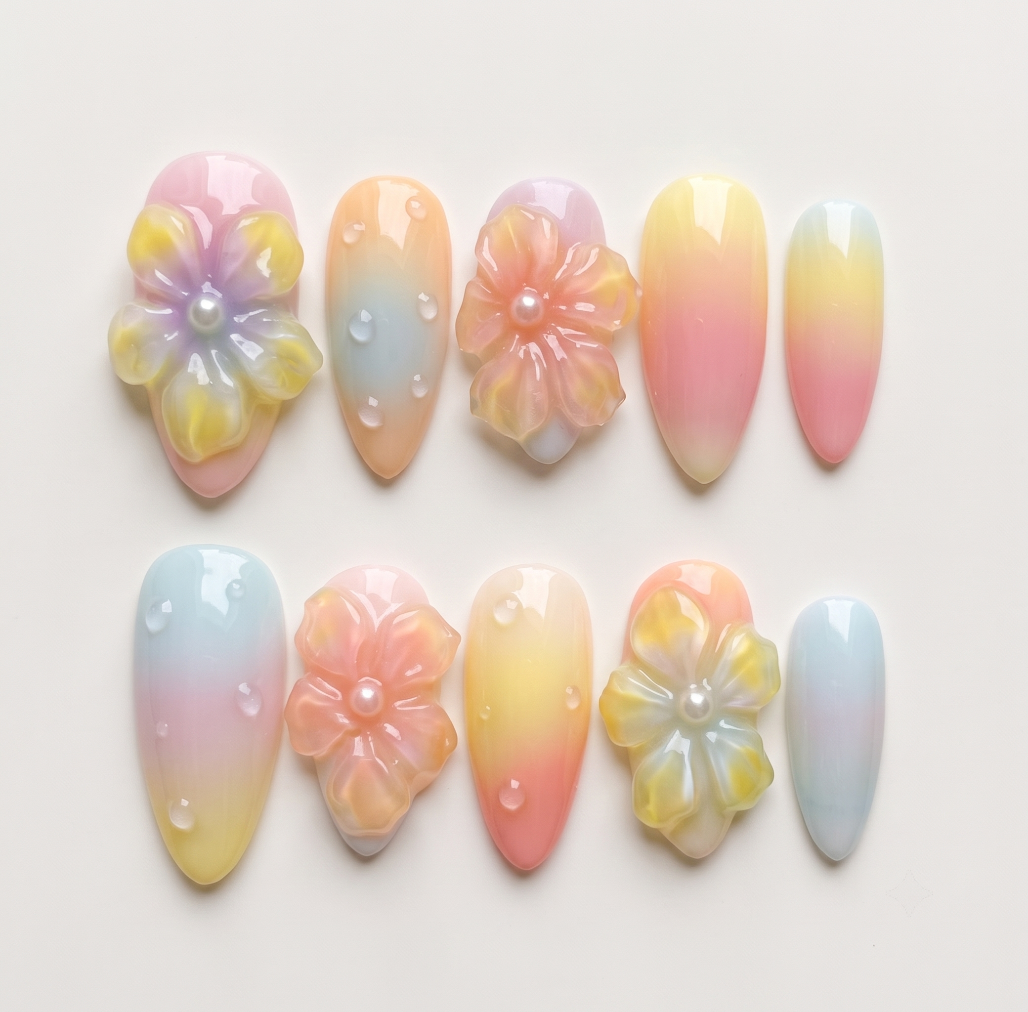 Pastel ombré press-on nails with 3D jelly flowers, pearl centers, and clear water droplet accents.