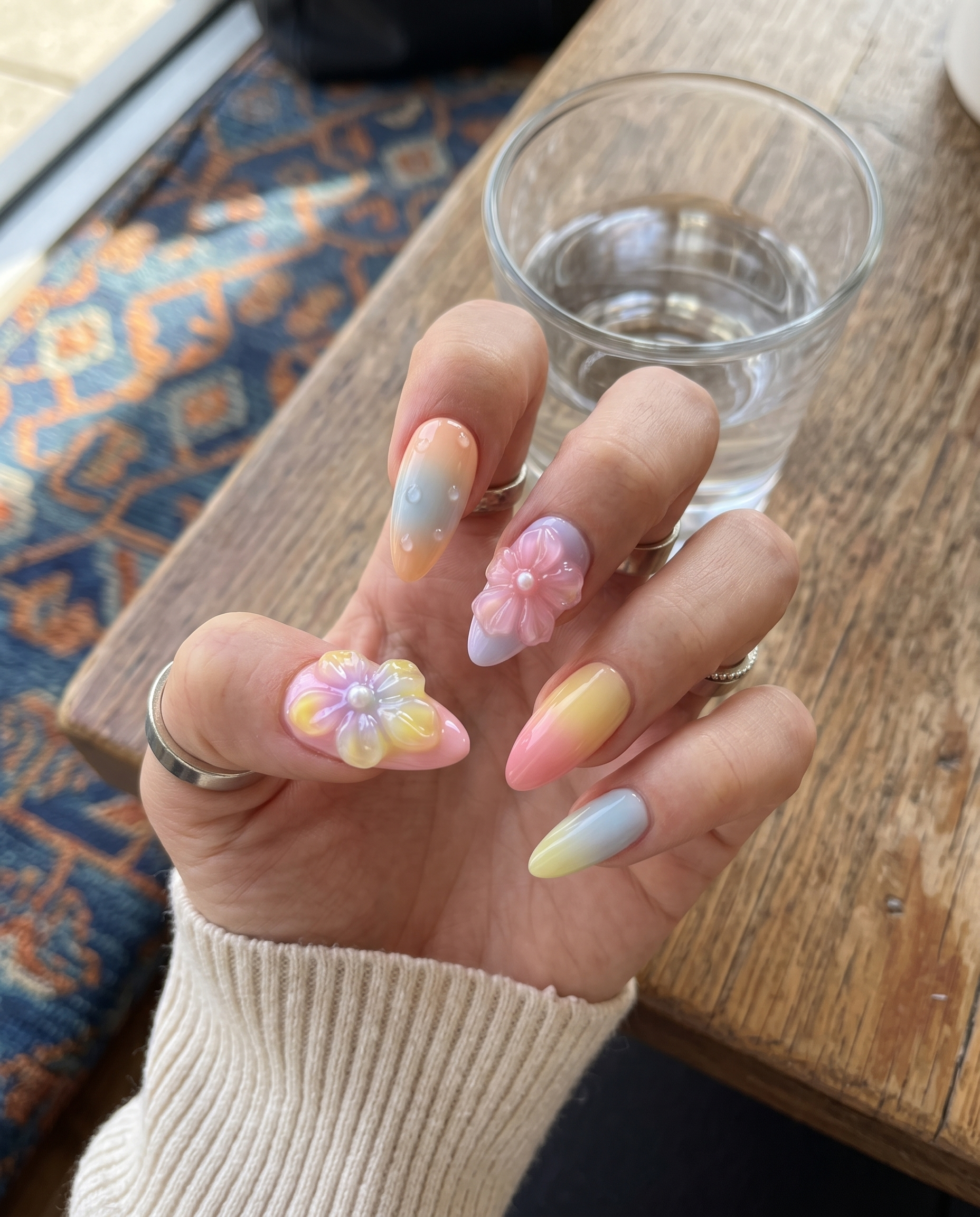 Pastel ombré press-on nails with 3D jelly flowers, pearl centers, and clear water droplet accents.