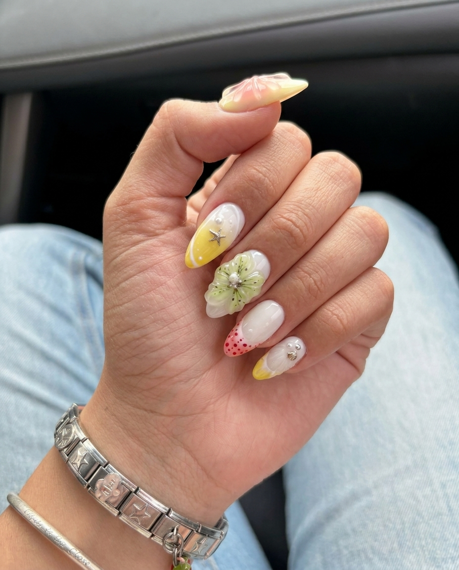 Pastel press-on nails featuring 3D flowers, starfish charms, ocean shells, and pearls.