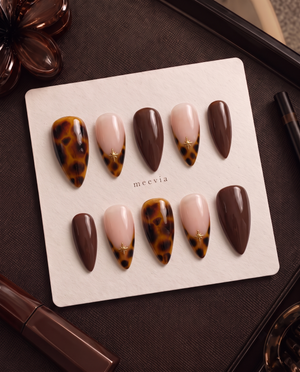 Amber tortoiseshell, chocolate brown, and nude pink star press-on nails