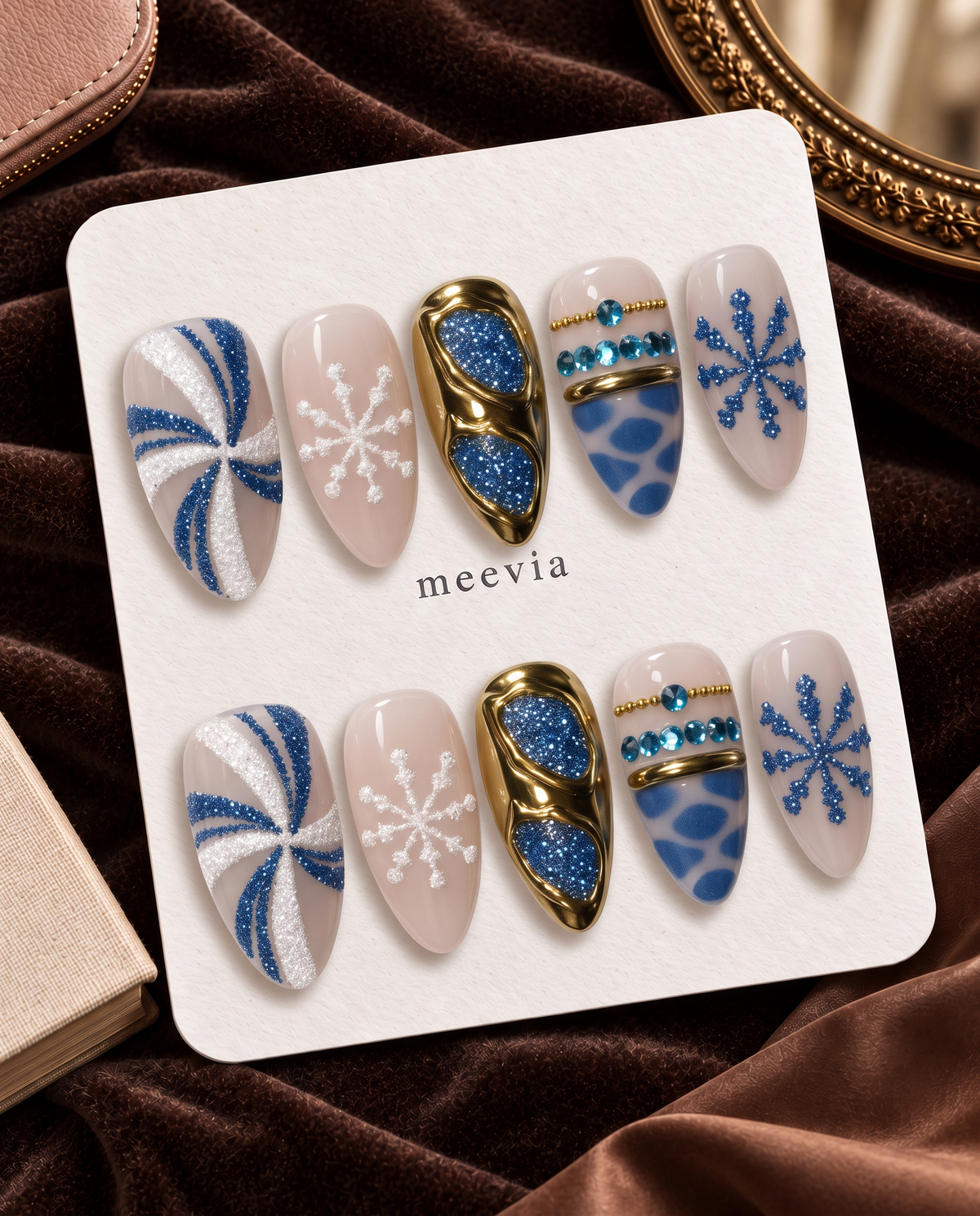 Blue and gold chrome snowflake press-on nails with glitter and rhinestone details