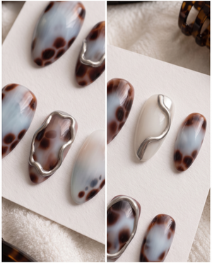 Blue and brown tortoiseshell chrome press-on nails with silver metallic accents