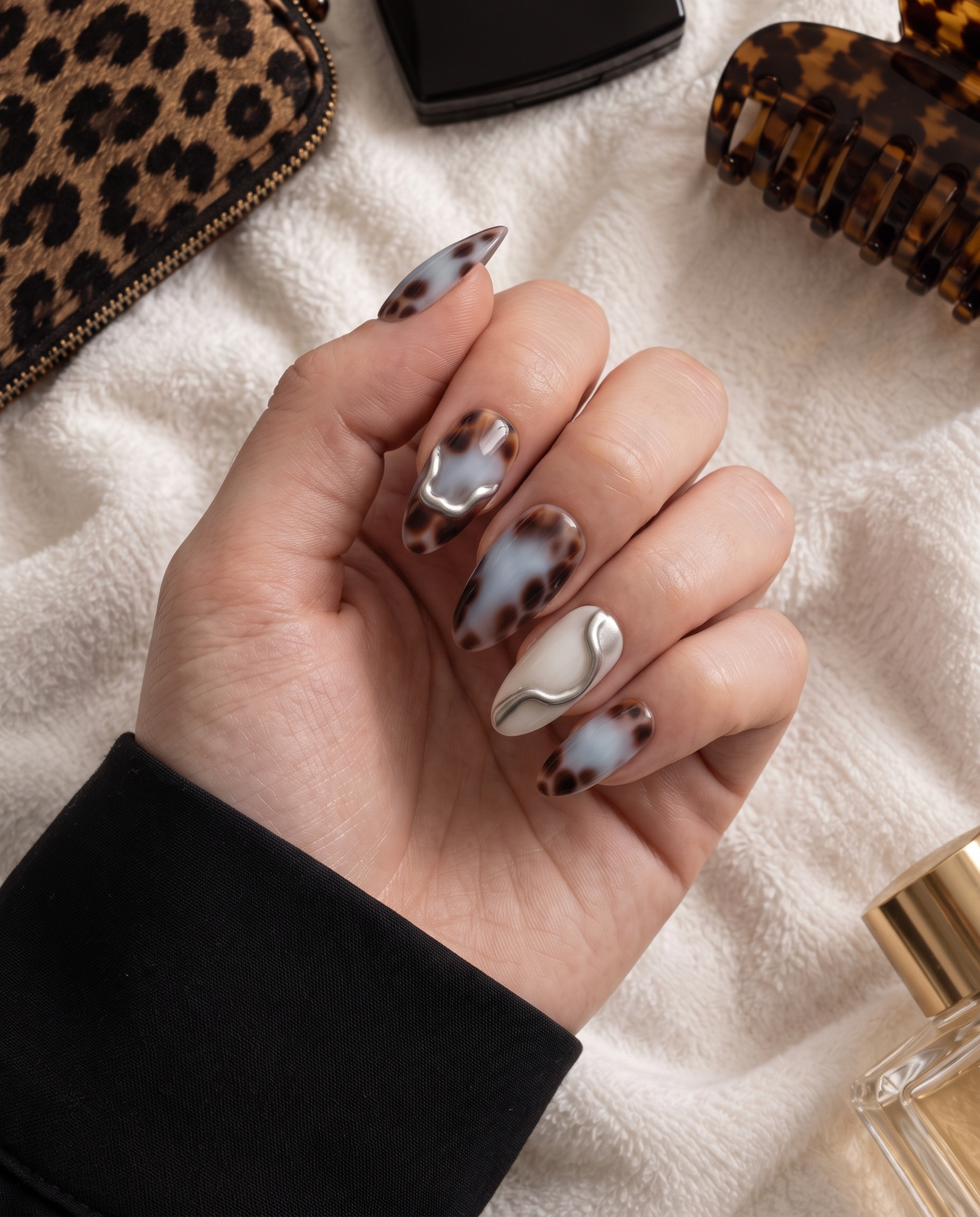 Blue and brown tortoiseshell chrome press-on nails with silver metallic accents