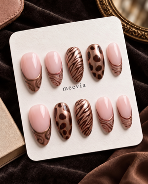Bronze metallic French tip press-on nails with pink polish, zebra stripes, and brown animal print accents