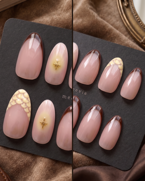 Glossy pink nude press-on nails with brown French tips, gold starburst accents, and cream floral details