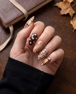 Brown plaid and abstract print press-on nails with glossy cream, caramel, and chocolate designs
