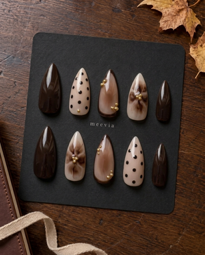 Brown and nude floral and polka dot press-on nails with gold bead accents