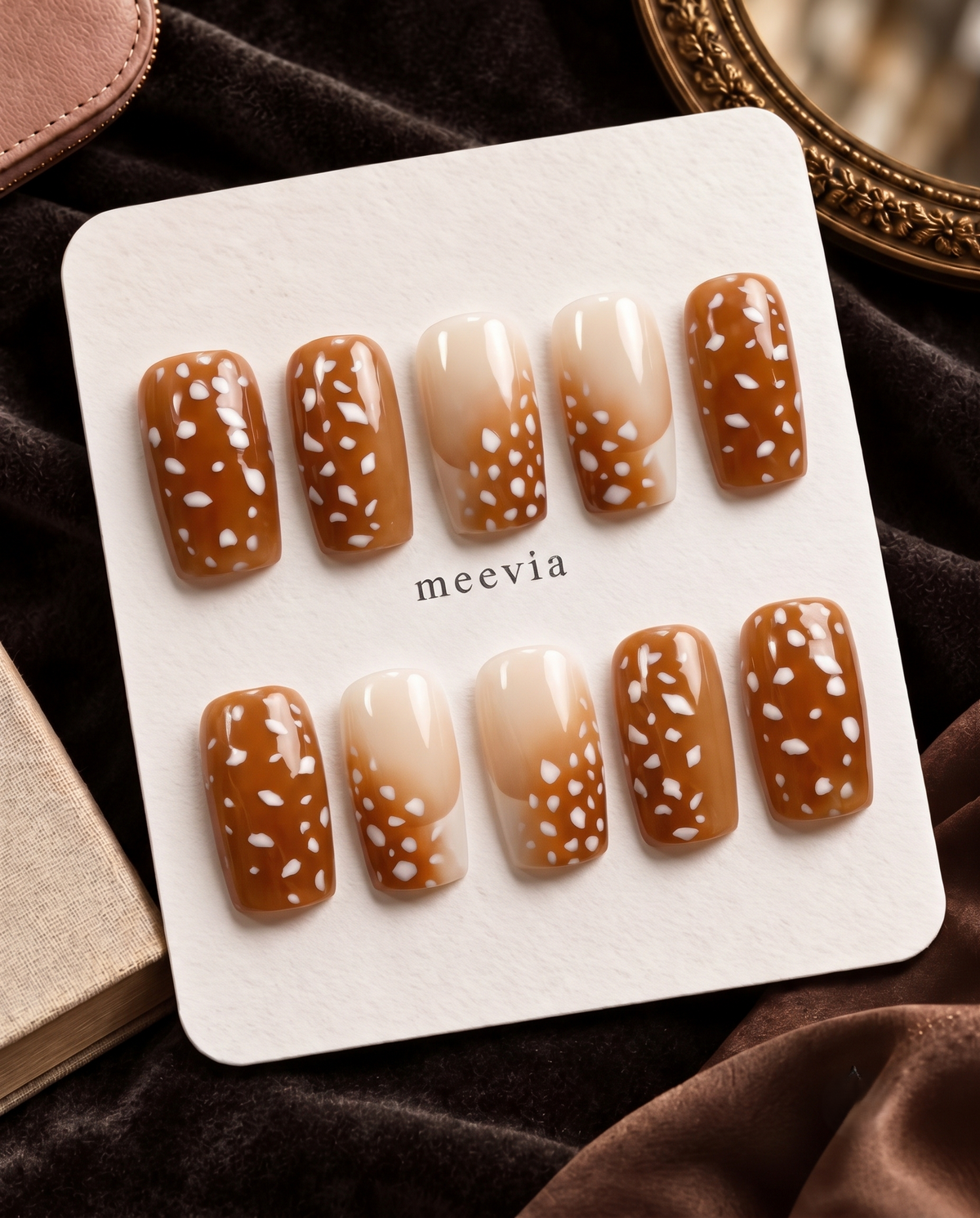 Brown and nude ombre press-on nails with glossy white spotted details