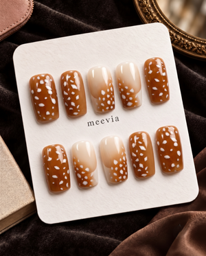 Brown and nude ombre press-on nails with glossy white spotted details