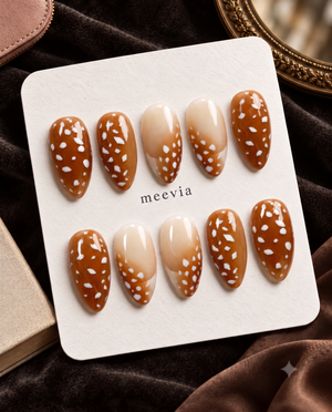 Brown and nude ombre press-on nails with glossy white spotted details