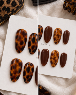 Brown glossy tortoiseshell press-on nails with amber and deep brown patterns
