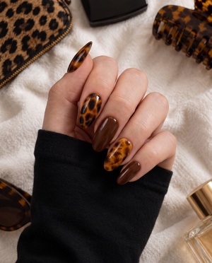 Brown glossy tortoiseshell press-on nails with amber and deep brown patterns