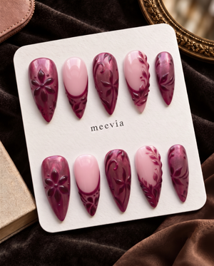 Burgundy and pink floral almond press-on nails displayed on a Meevia card