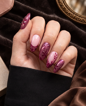 Burgundy and pink floral almond press-on nails displayed on a Meevia card