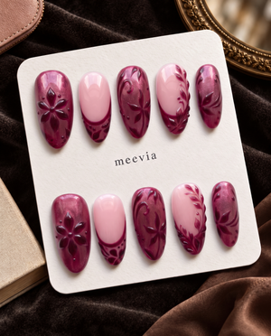 Burgundy and pink floral almond press-on nails displayed on a Meevia card